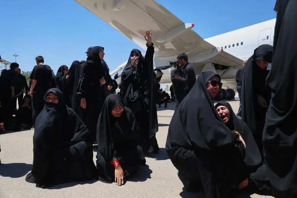 Women react as the coffin of Iranian Supreme Leader Ayatollah Ali Khamenei arrives at Hasheminejad airport.