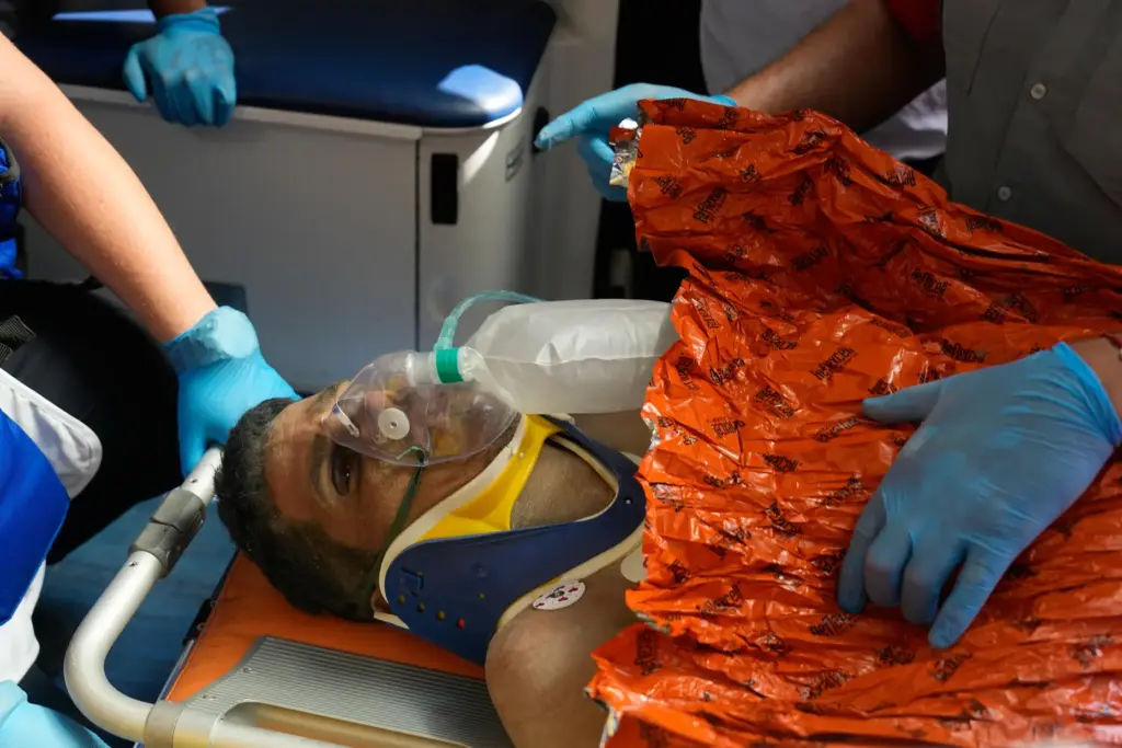 Rescue workers attend to Hernán Alberto Gil Flores after he...