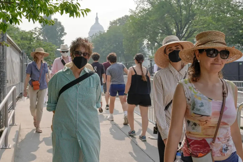 Visitors wear face masks, as smoke from wildfires blankets the...