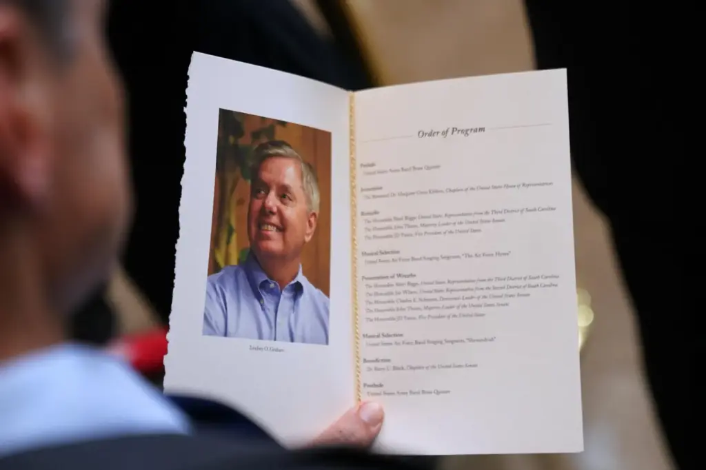 A guest looks at the program during the service for Sen. Lindsey Graham.