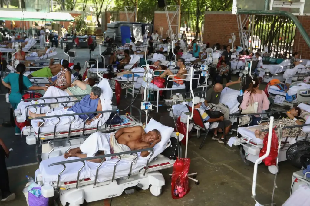 Patients from a clinic evacuated due to earthquake damage lie in beds.