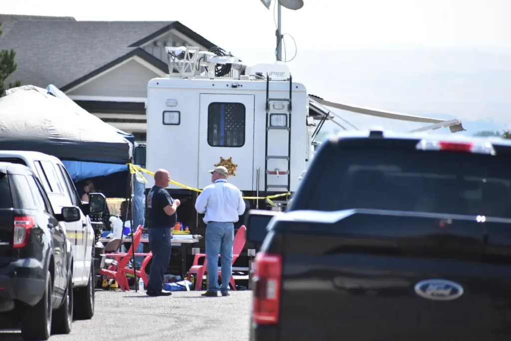 Investigators work at the scene Tuesday, Aug. 25, 2026, where...
