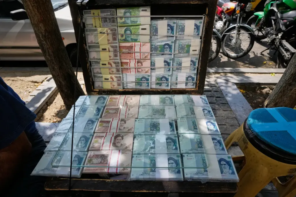 ranian banknotes are displayed by a street money exchanger.