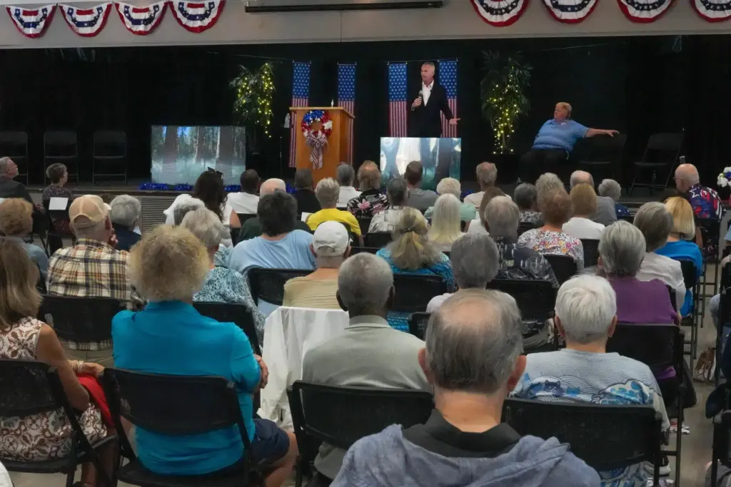 Florida Democratic gubernatorial candidate David Jolly, back center, speaks to...
