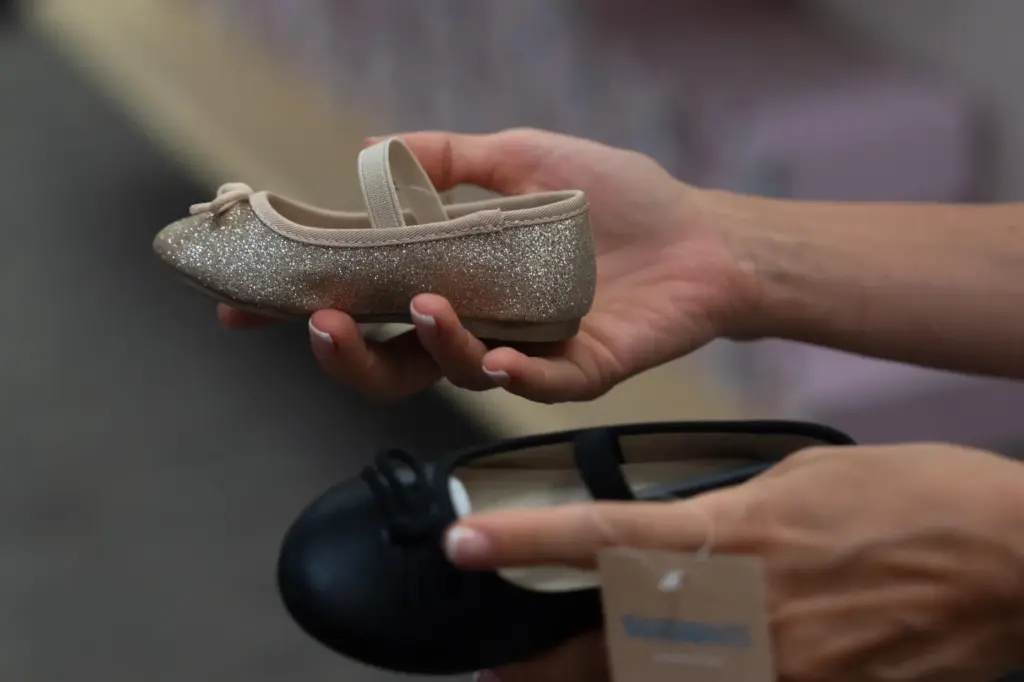 Khrystyna Lialina shops for shoes for her daughter at a...