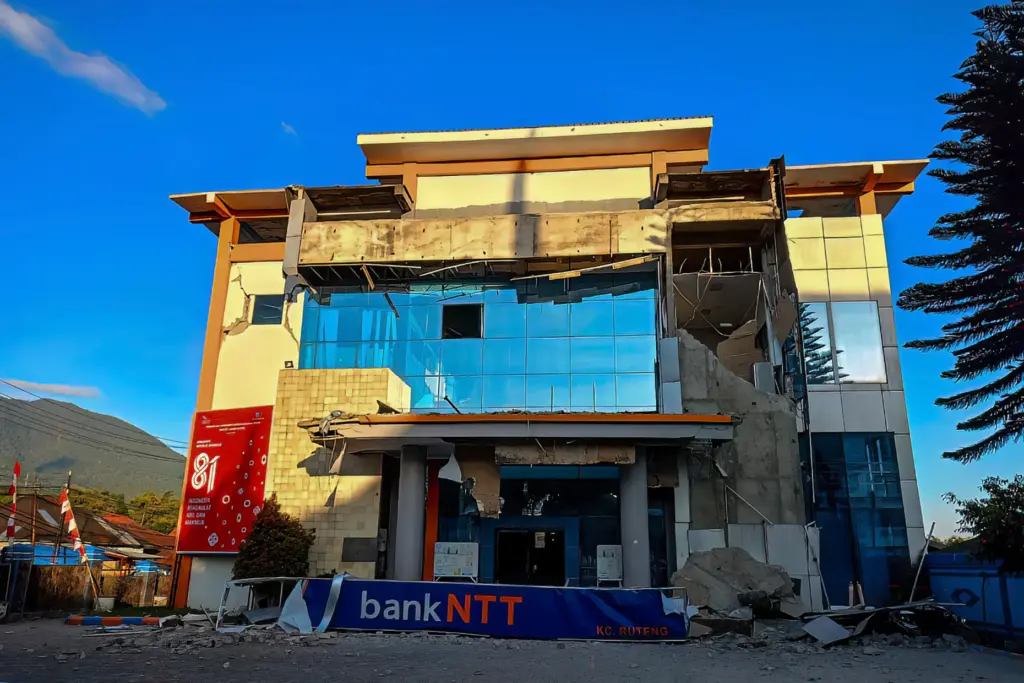 A damaged building is seen following a 7.0-magnitude earthquake in...