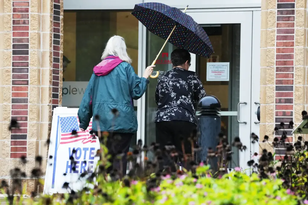 Voters walk into Maplewood City Hall on the first day...