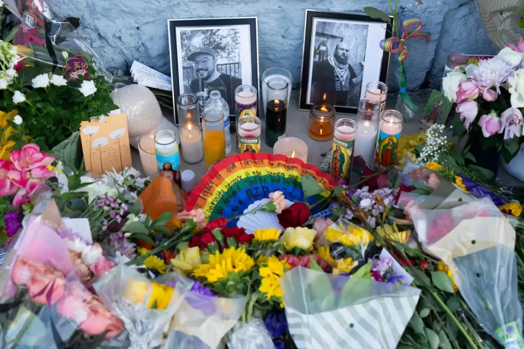 A growing memorial sits outside the Venture-N bar in Tucson,...