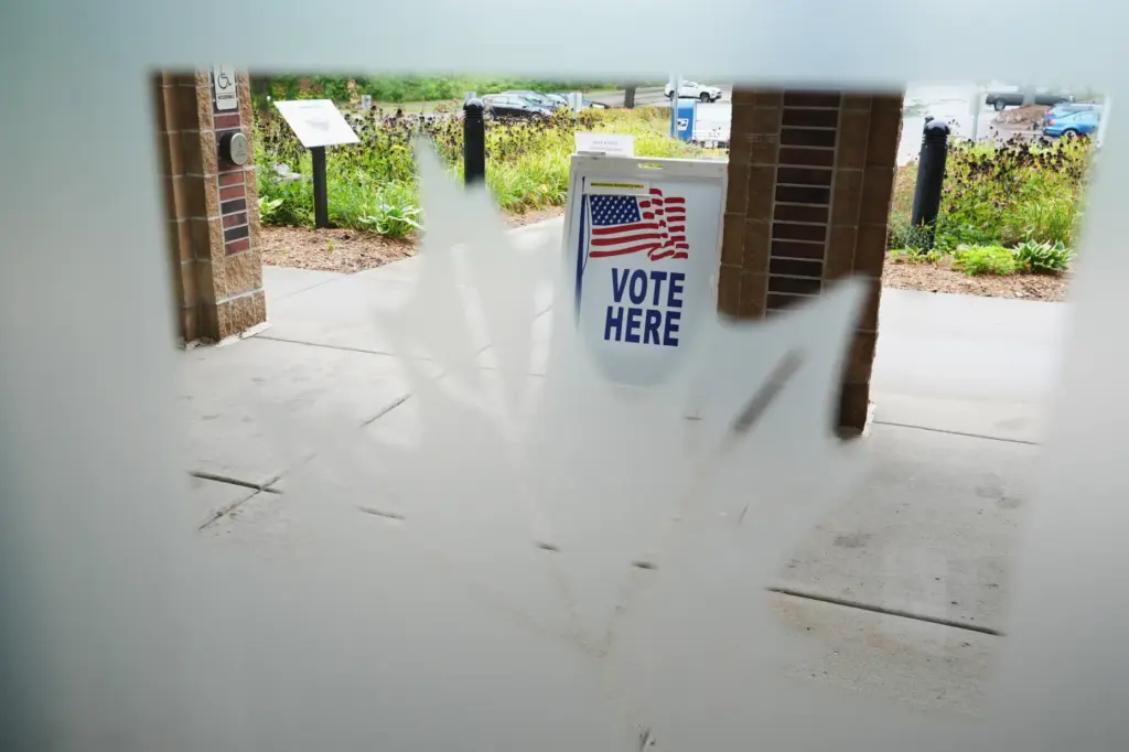 A sign welcomes voters on the first day of early...