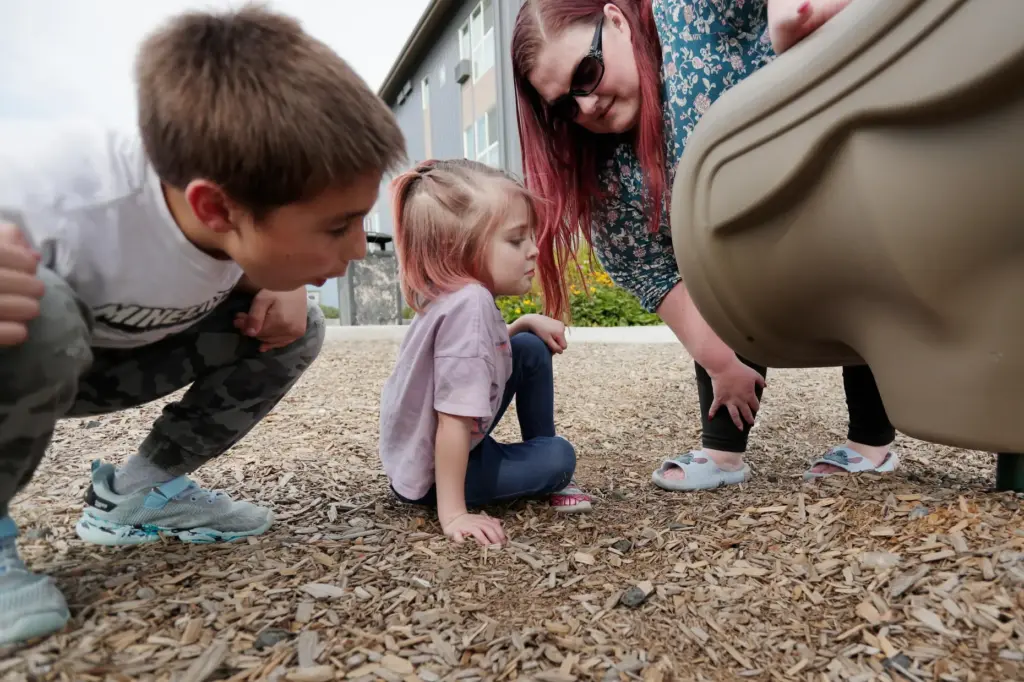 Kian Reed, left, his sister Evie Reed, center, and mother...
