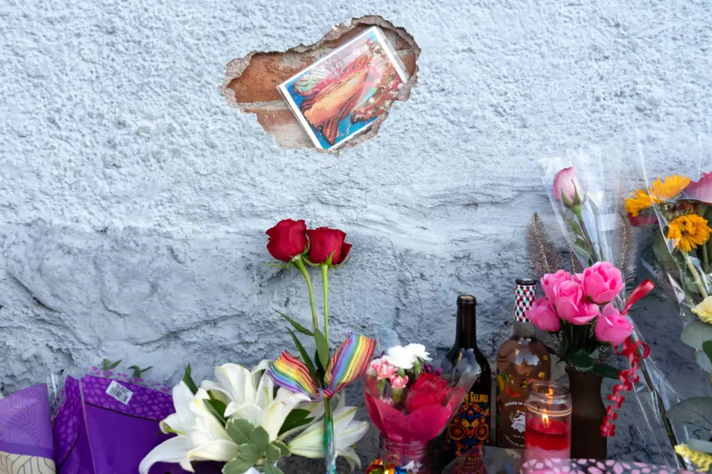 A growing memorial sits outside the Venture-N bar in Tucson,...