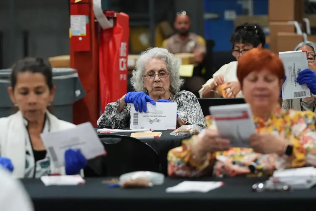 Election workers sort vote-by-mail ballots at the Miami-Dade County Supervisor of Elections Office.