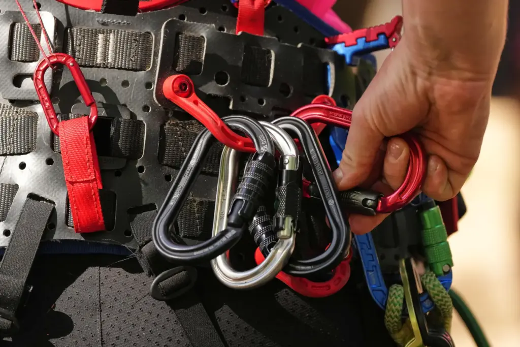 Anna Petova, of the Czech Republic, adjusts her carabiners as...