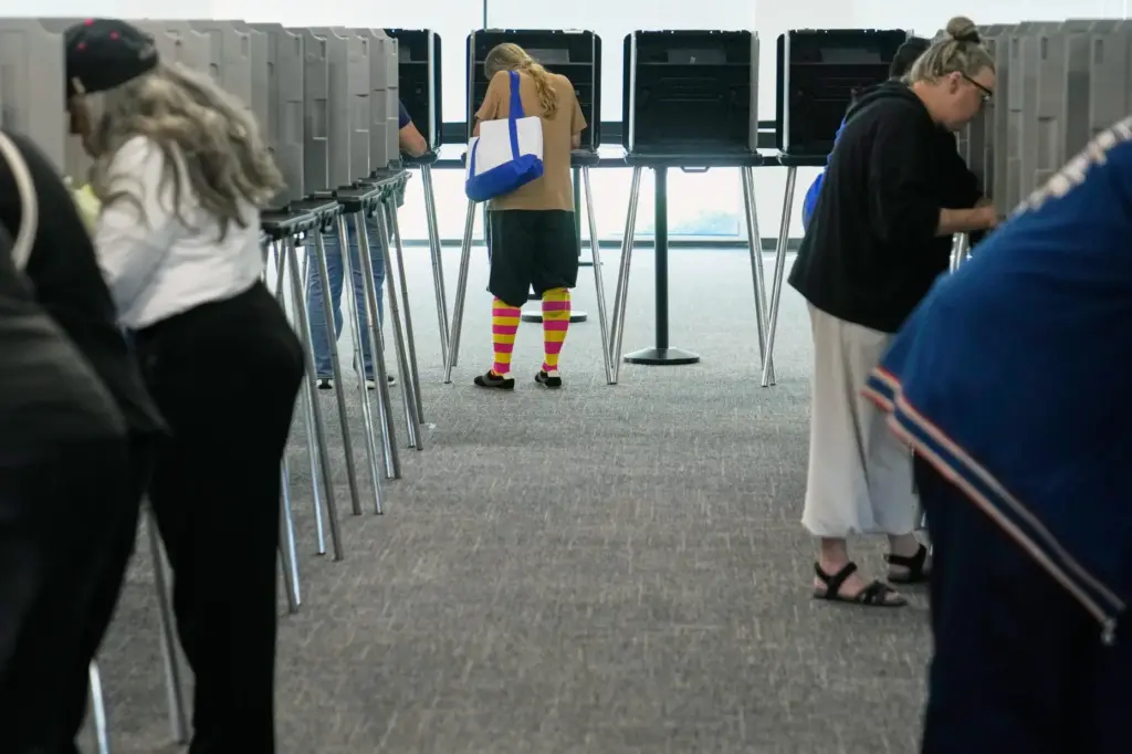 Voters fill in their ballots in privacy booths during early in-person voting in Cleveland.