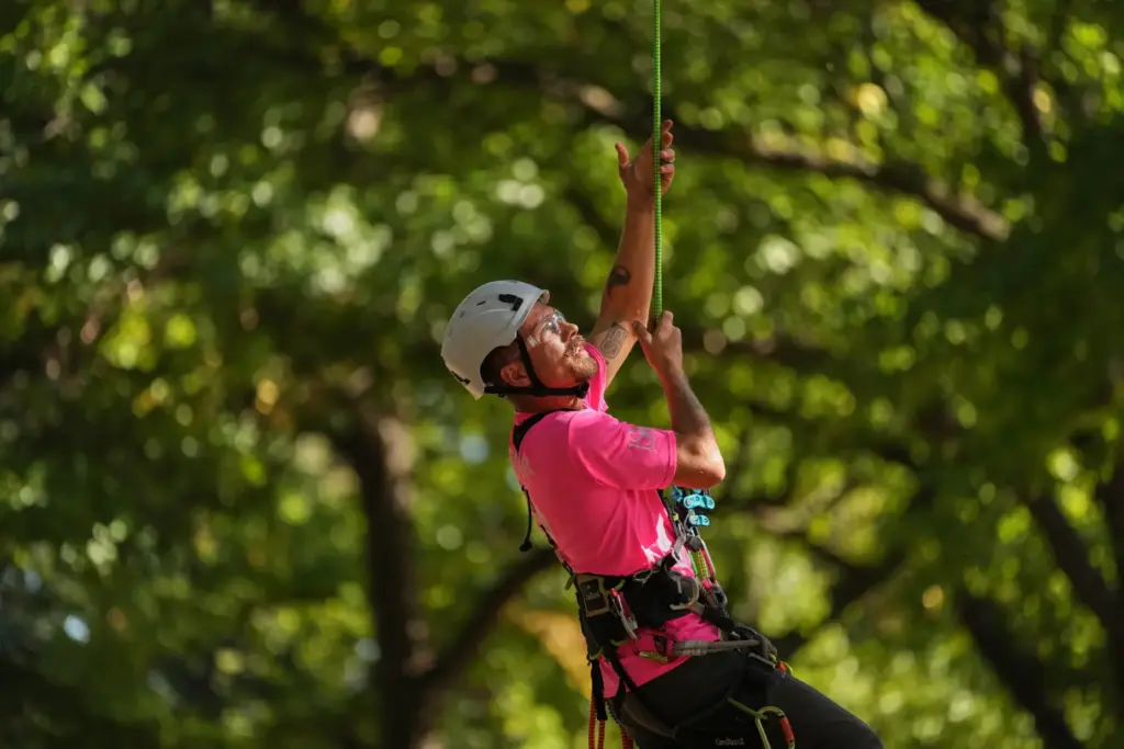 Alex Bower pulls himself up as he participates in the...