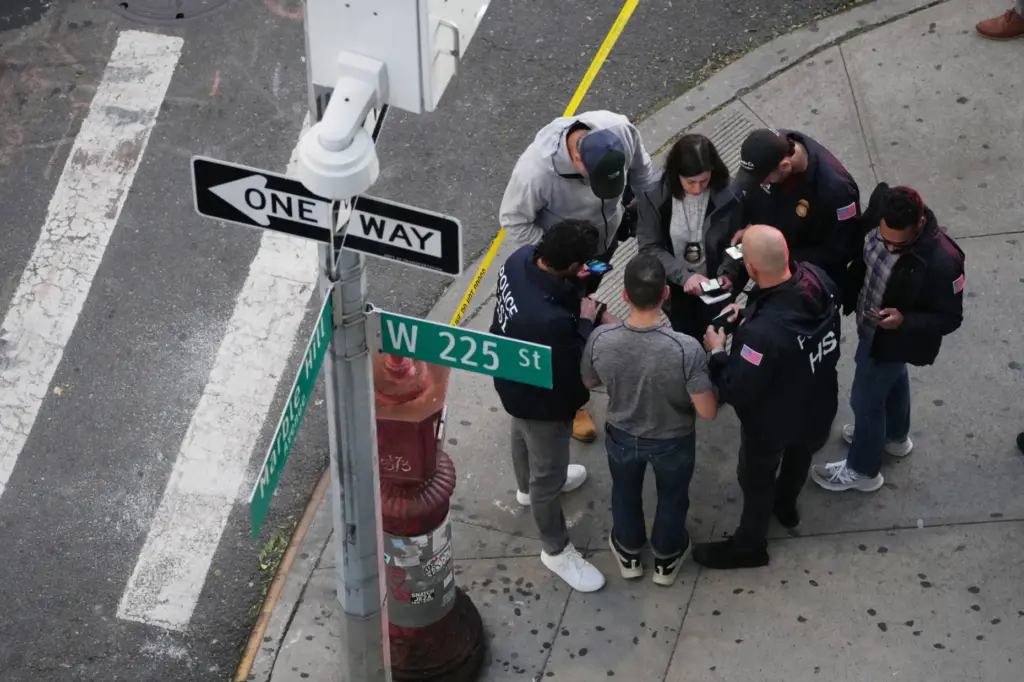 Law enforcement officers investigate after ICE agents shot and wounded...