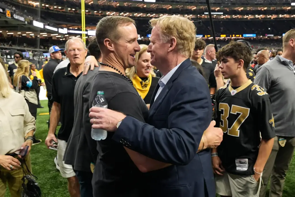 Former New Orleans Saints quarterback Drew Brees, middle left, greets...