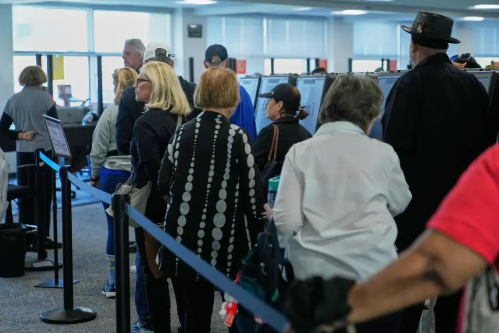Voters wait in line to receive their ballots at early in-person voting in Cleveland.