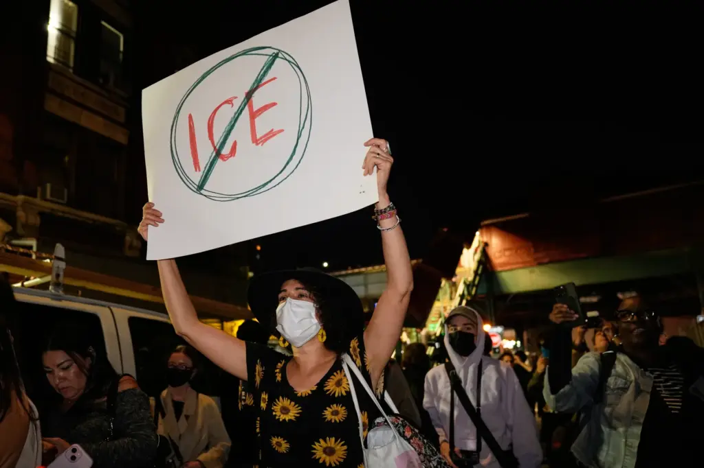 A person holds a sign near the scene of a...