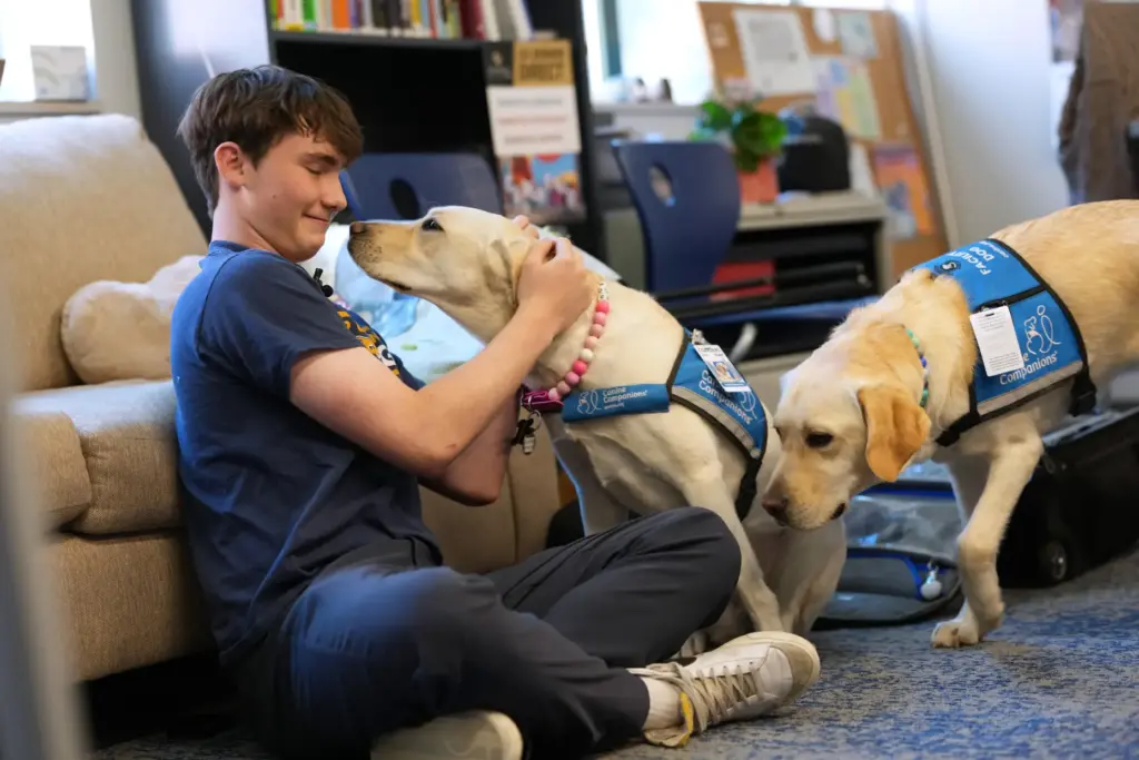 Fisher Helbraun, a junior at Evergreen High School, visits with...