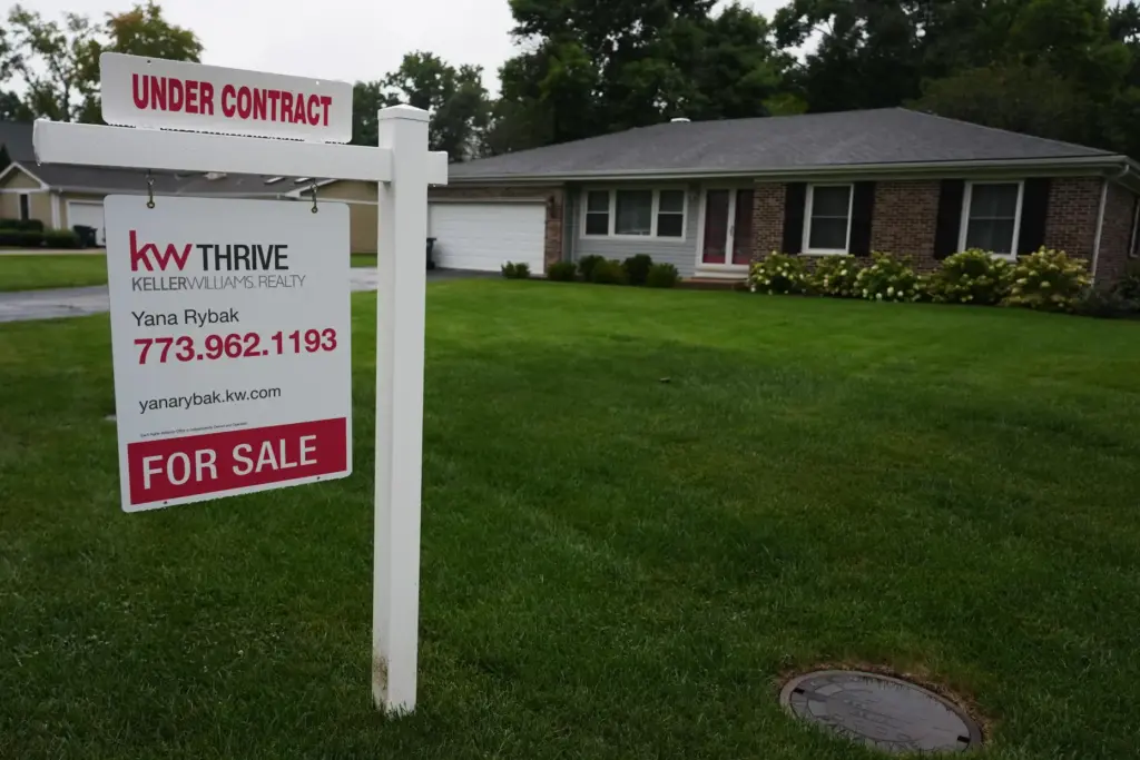 FILE – For sale sign is seen outside of a...